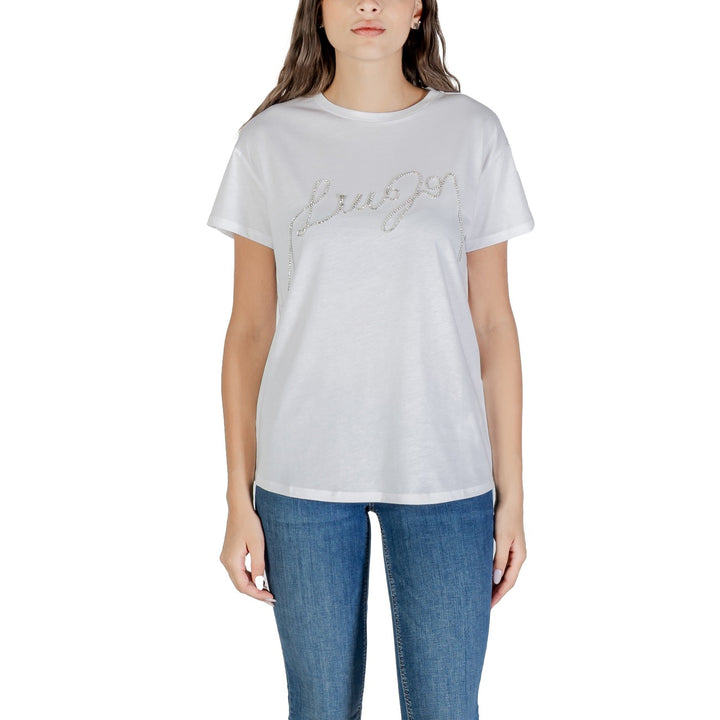 Image 1 : T-shirt femme Liu Jo blanc à col rond avec logo cursif en strass argentés, vue de face portée avec un jean — Delvale