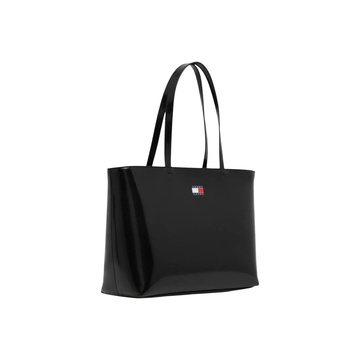Image 2 : Sac cabas Tommy Hilfiger noir, silhouette trapézoïdale structurée, détail badge métal logo Flag visible — Delvale
