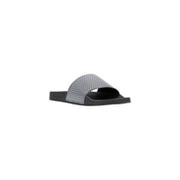 Image 2 : Mules Armani Exchange homme noires en PVC, détail du motif imprimé signature — Delvale