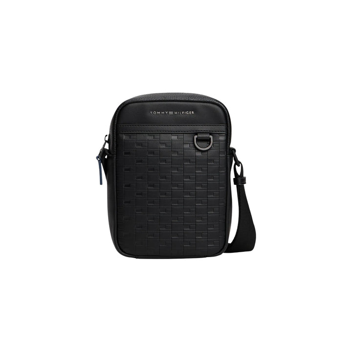 Image 1 : Sacoche Tommy Hilfiger homme noir monogramme TH gaufré zip métal sombre sangle tissée vue de face — Delvale