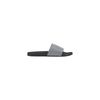 Image 1 : Mules Armani Exchange homme noires en PVC avec motif imprimé, vue de profil — Delvale