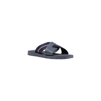 Image 2 : Mules Tommy Hilfiger homme cuir bleu marine, détail des bandes croisées et semelle crantée caoutchouc, fond blanc — Delvale