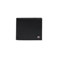 Image 1 : Portefeuille Tommy Hilfiger homme en cuir noir texturé côtelé, vue de face avec plaquette logo métal — Delvale