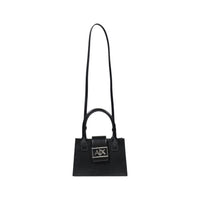 Image 4 : Mini sac Armani Exchange jaune pâle porté à la main, format compact et élégant mis en situation — Delvale