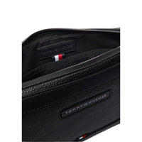 Image 5 : Pochette zippée Tommy Hilfiger homme noire posée à plat, format business élégant et compact — Delvale