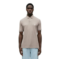 Polo Armani Exchange homme beige piqué logo AX brodé — vue de face portée — Delvale