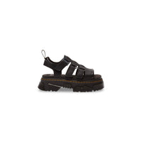 Image 1 : Sandales plateforme Dr. Martens Mattison en cuir noir, vue de profil gauche, brides ajustables et semelle crantée épaisse avec surpiqûres jaunes — Delvale