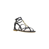 Image 2 : Sandale plate Liu Jo noire à lanières et détails dorés, semelle beige visible, maintien cheville réglable — Delvale