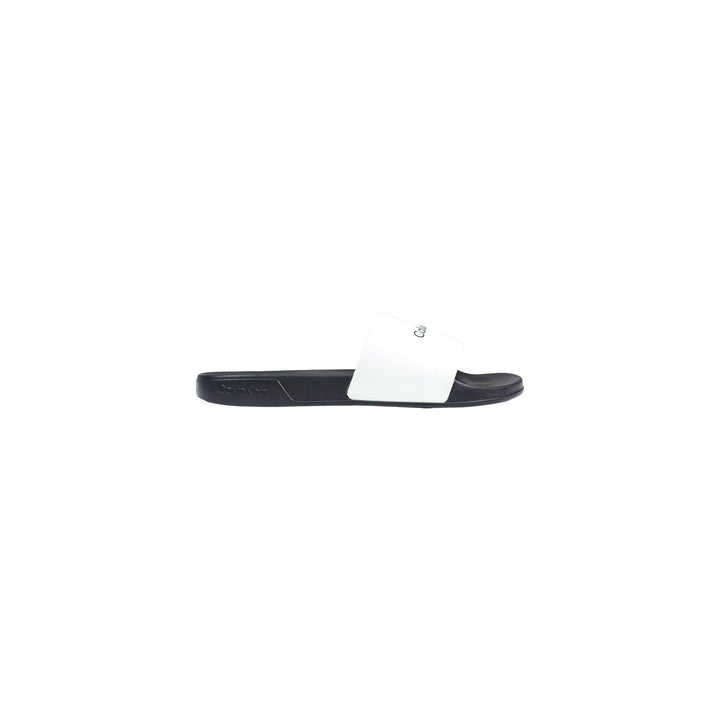Image 1 : Mule slide Calvin Klein homme à bride blanche logo monogram sur semelle sombre EVA, vue de profil gauche — Delvale