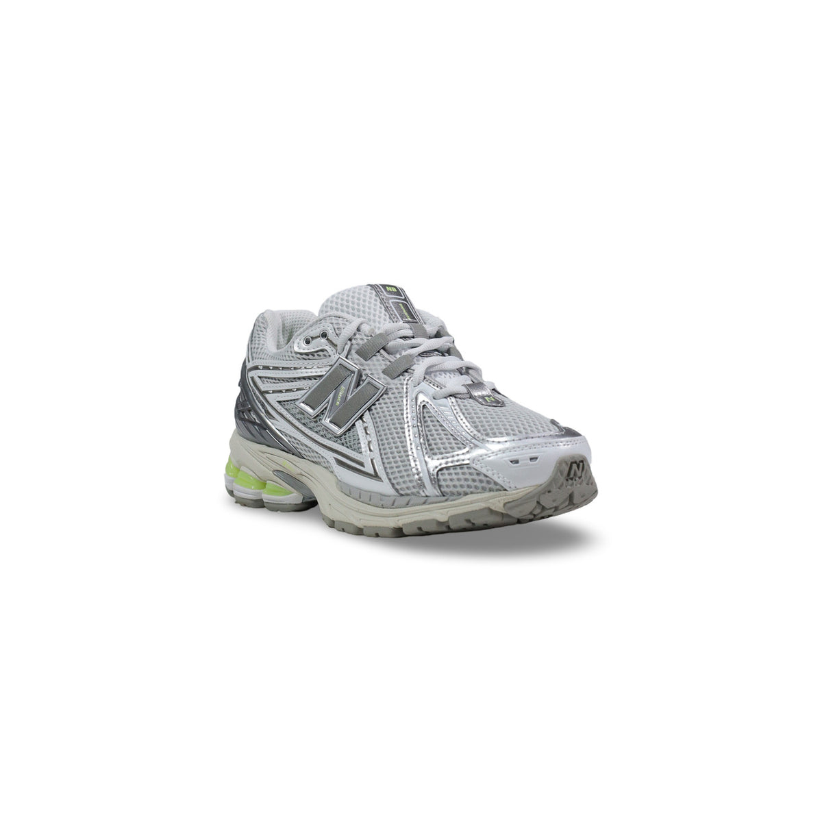 Trois-quarts avant : New Balance 1906R homme U19063NQ — vue trois-quarts, logo N argenté mat, capsules talon vert fluo visibles, semelle blanc cassé