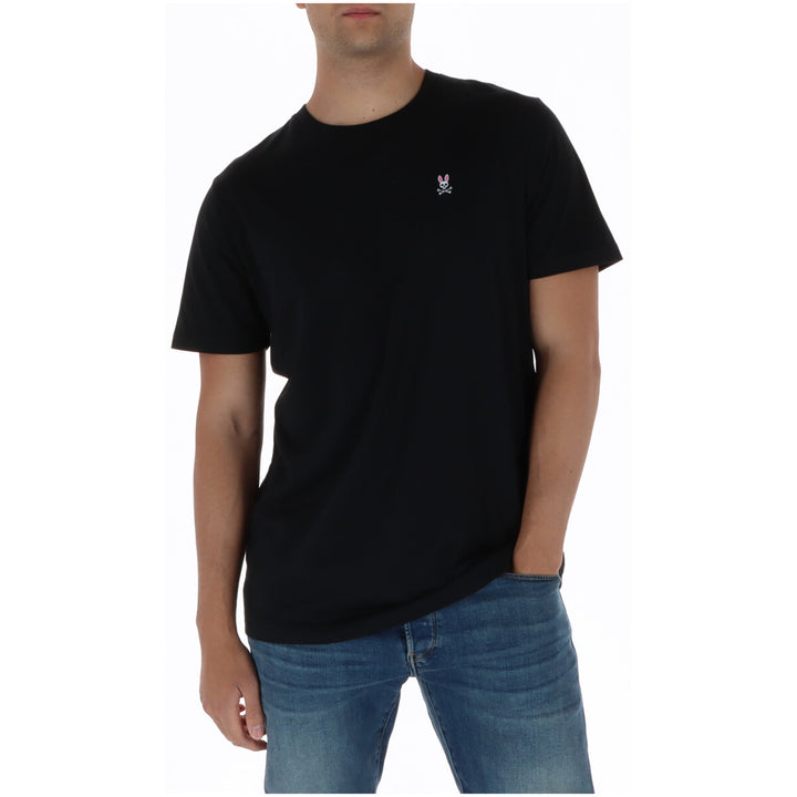Image 1 : T-shirt homme Psycho Bunny noir à col rond avec logo lapin brodé sur la poitrine gauche, porté avec un jean — Delvale