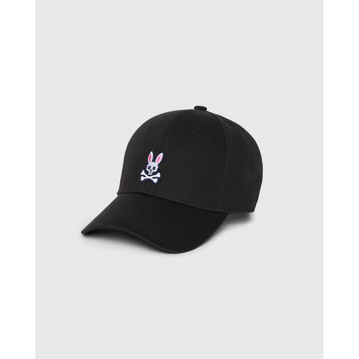 Image 1 : Casquette Psycho Bunny noire de trois quarts avec logo skull bunny brodé en façade sur fond gris clair — Delvale