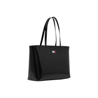Image 2 : Sac cabas Tommy Hilfiger noir, silhouette trapézoïdale structurée, détail badge métal logo Flag visible — Delvale