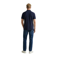 Image 3 : Vue de trois quarts du polo Gant Shield homme bleu marine, col polo structuré et patte de boutonnage visible — Delvale